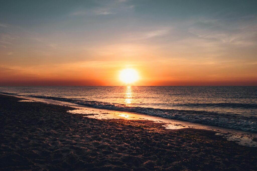 Sunset over the Gulf Shores beach with colorful sky and ocean