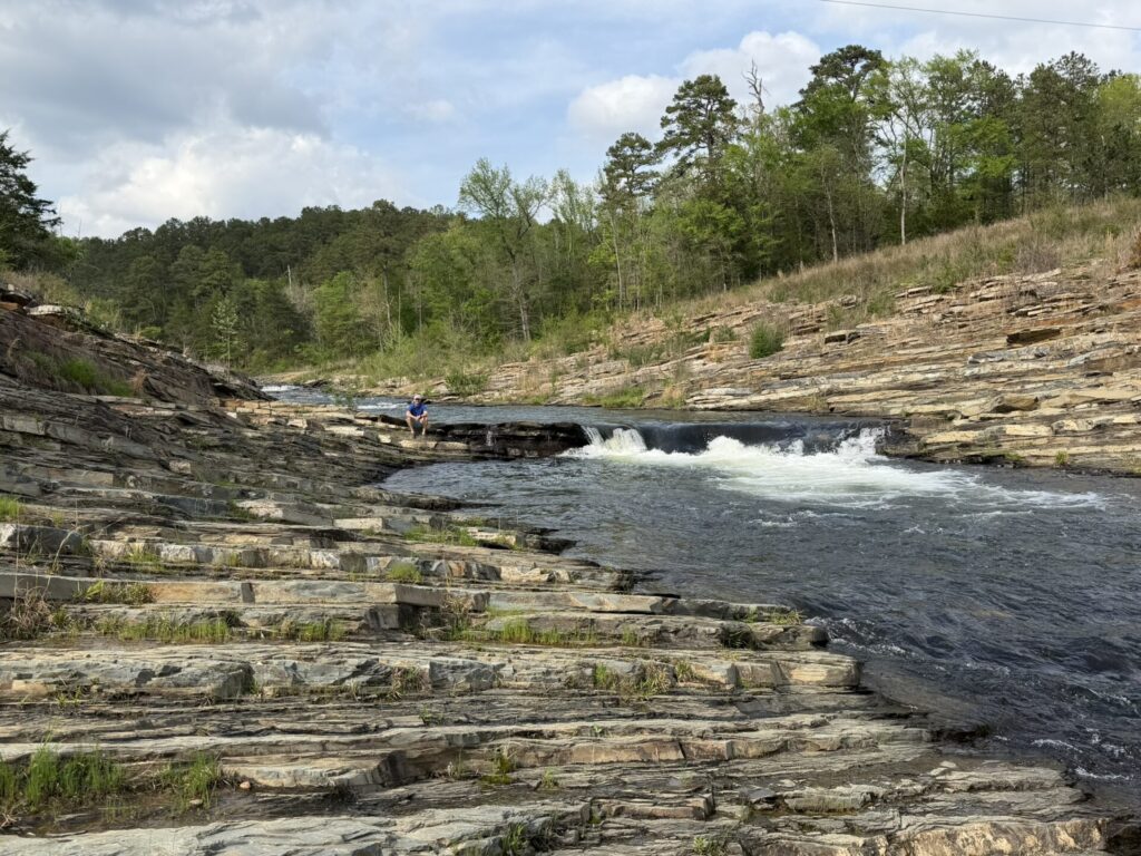 Small waterfall and layered rock formations along Cedar Creek Trail in Broken Bow, Oklahoma.