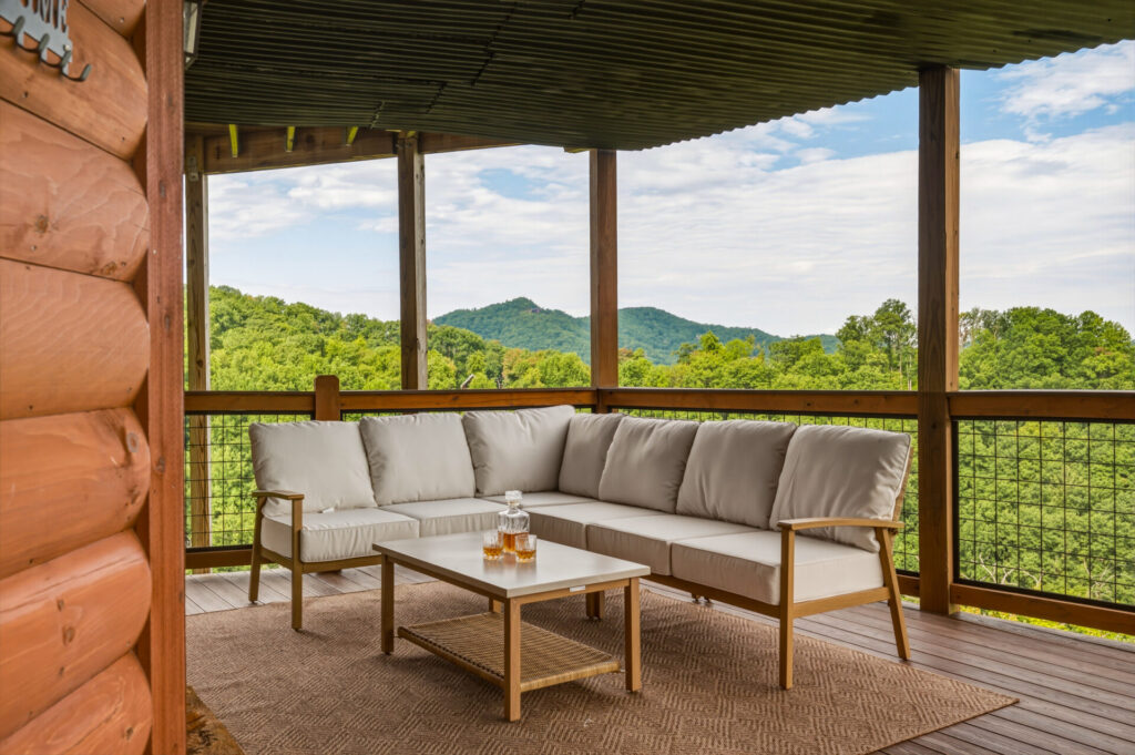 Covered deck with comfortable outdoor seating and mountain views