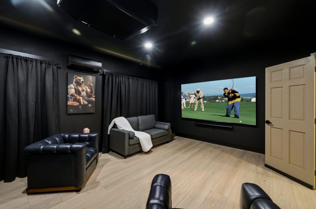 Private theater room with large screen and reclining seats at Bear Ridge Escape