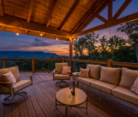 Covered outdoor living area with Smoky Mountain views at twilight