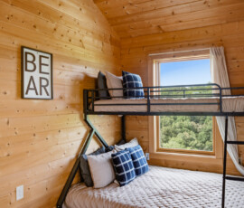 Bunk bedroom with rustic cabin decor at Bear Ridge Escape