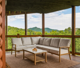 Covered deck with comfortable outdoor seating and mountain views