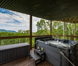 Deck overlooking layers of Smoky Mountain scenery at Bear Ridge Escape