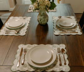 Dining table set for four with white dinnerware and floral centerpiece at After the Trail cabin in Gatlinburg.